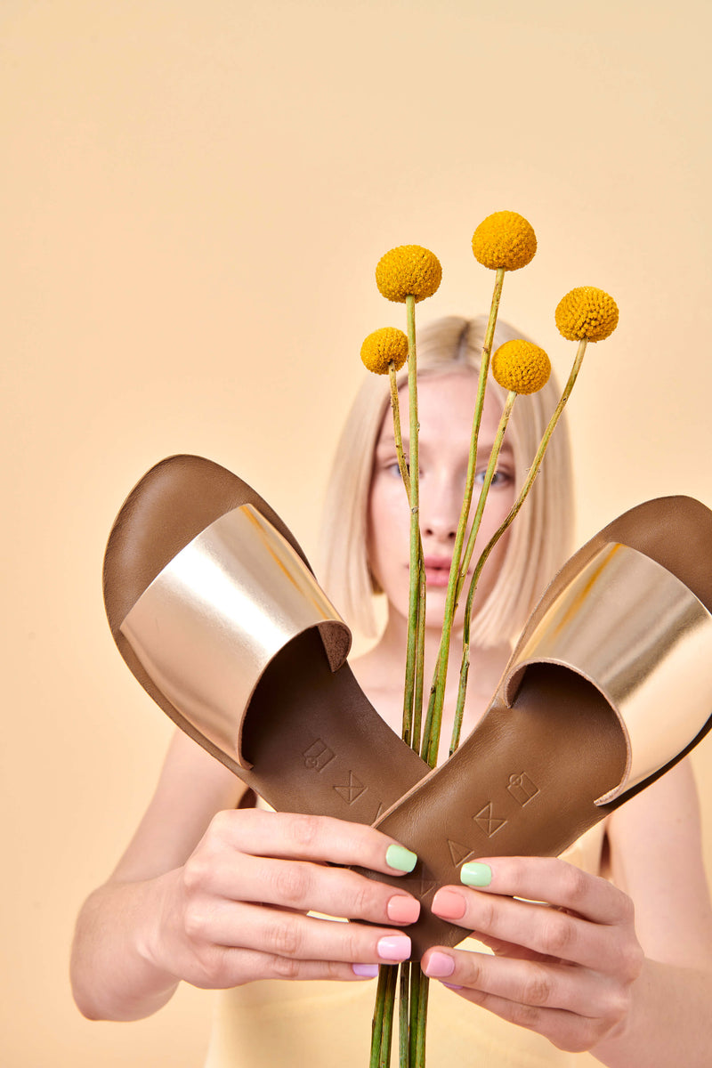 Model wearing the handmade Rock women's slip-on leather sandals in olive insole with gold straps / GOLD