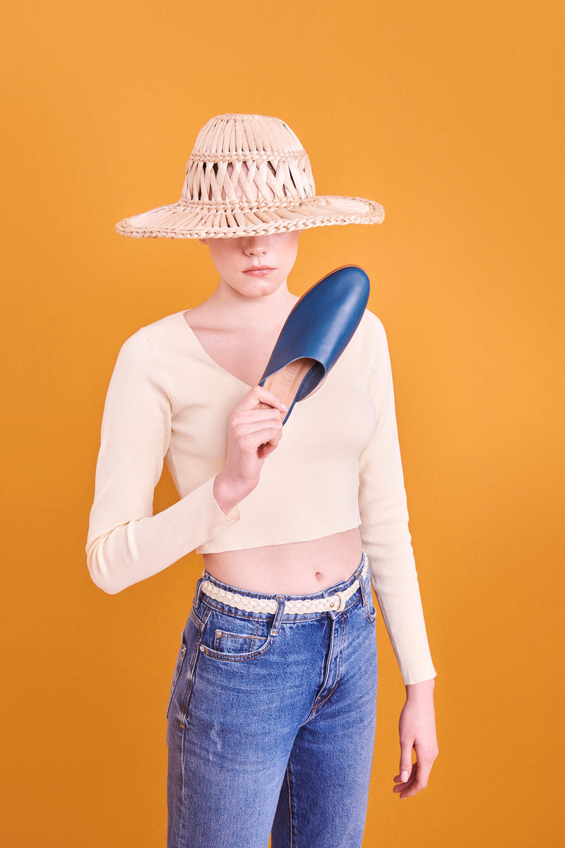 Model wearing handmade Mules women's slip-on leather sandals in mediterranean / MEDITERRANEAN