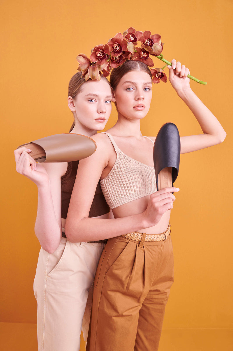 Model wearing handmade Mules women's slip-on leather sandals in black / BLACK