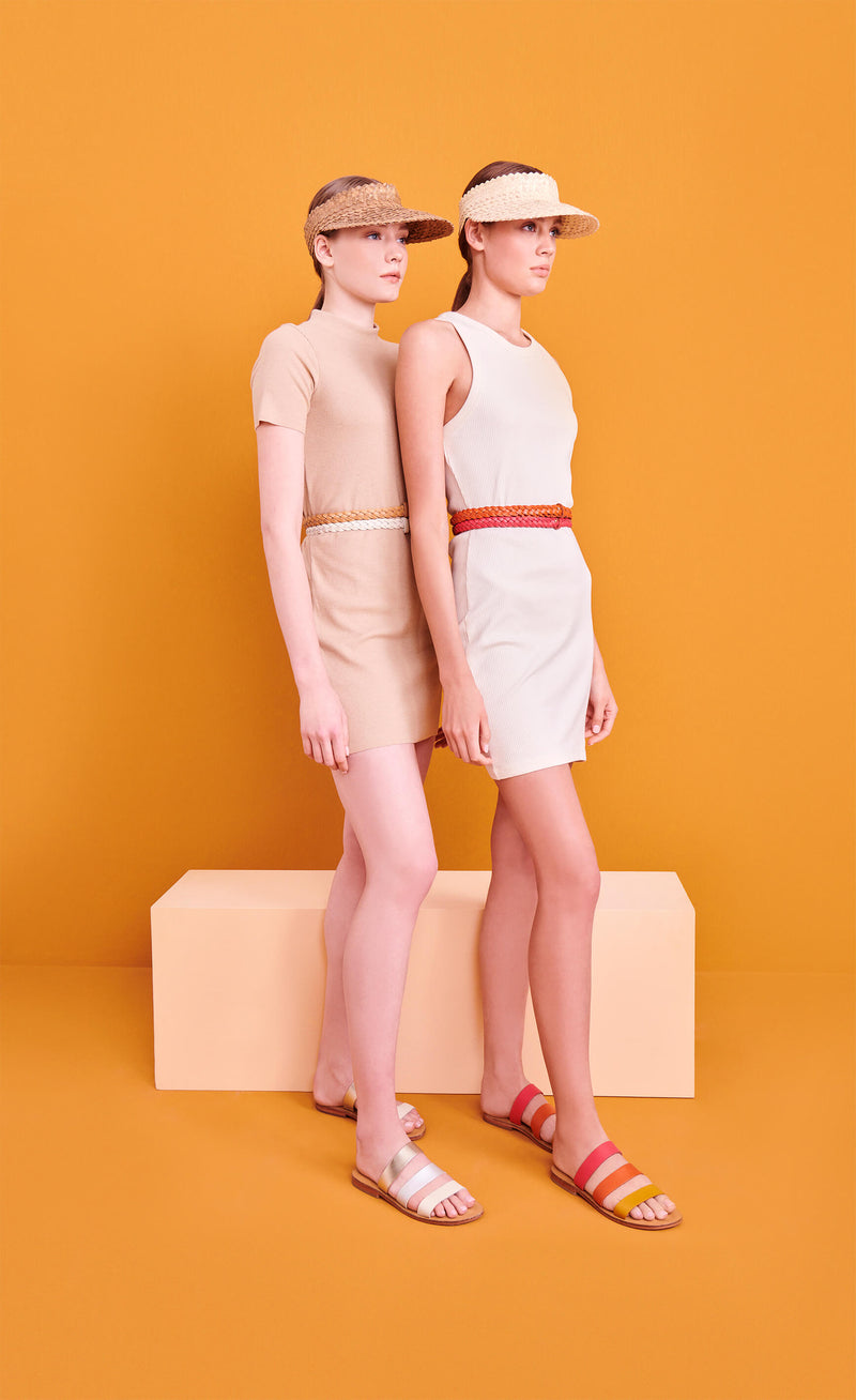 Model wearing the handmade Sky women's slip-on leather sandals in natural tan insole with pomegranate, orange and yellow straps / SUNSET