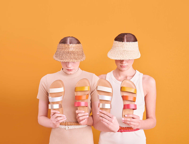 Model wearing the handmade Sky women's slip-on leather sandals in natural tan insole with pomegranate, orange and yellow straps / SUNSET
